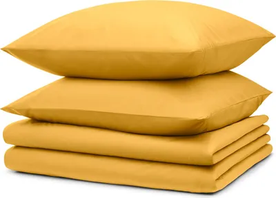 A stack of yellow bedding items, including pillows and a folded sheet or duvet cover, is shown against a white background.