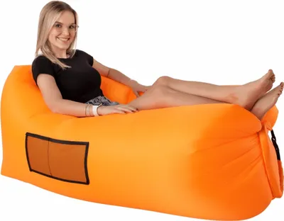 A woman is sitting on an orange inflatable lounger.