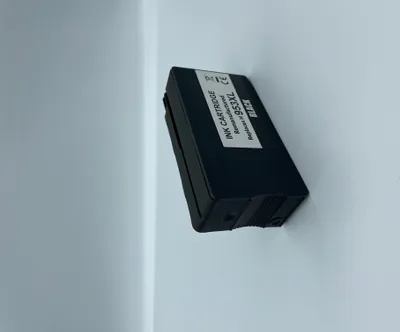 A black ink cartridge is shown on a light gray and white background.