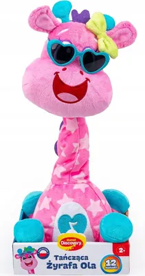 A pink plush giraffe toy with sunglasses and a bow, sitting in its packaging.