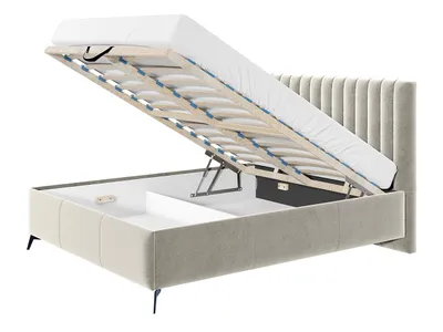 A bed with its storage compartment open, revealing the gas lift mechanism and slatted base.