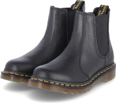 A pair of black Dr. Martens Chelsea boots.