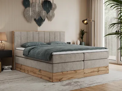 A bedroom scene featuring a large boxspring bed.