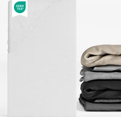 A white fitted sheet is shown on the left, with a stack of folded sheets in various colors on the right.