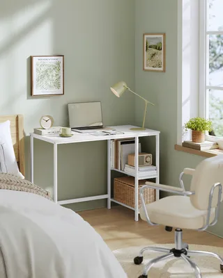 A bedroom corner with a desk, chair, and bed.
