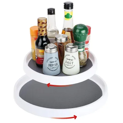 A two-tiered rotating organizer filled with various spice bottles and containers.