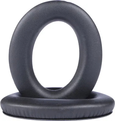 Two black ear pads for headphones are stacked on top of each other against a white background.