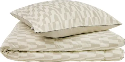 A stack of bedding, including a pillow and a duvet cover, with a geometric pattern.