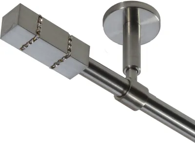 A close-up view of a modern curtain rod with a decorative end piece and a ceiling mount.