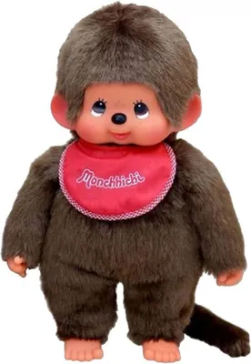 A Monchhichi doll wearing a red bib.