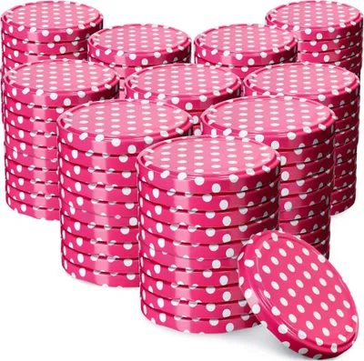 A collection of pink polka dot jar lids stacked in piles.