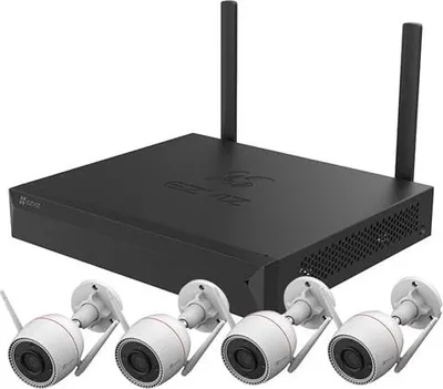 A black NVR unit with two antennas and four white security cameras.