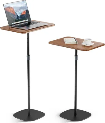 Two adjustable height side tables with wooden tops and black metal stands, one holding a laptop and the other a book and coffee cup.