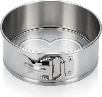 A stainless steel springform cake pan with a heart-shaped insert is shown against a white background.
