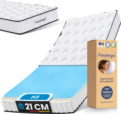 A mattress is shown with a cutaway revealing its layers, alongside its packaging.