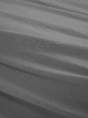 A close-up view of grey fabric with visible folds and texture.
