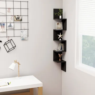 A corner of a room with a desk, a lamp, and a wall-mounted shelf unit.