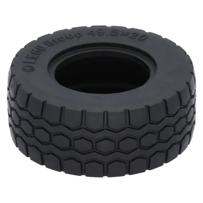 A close-up studio shot of a single black LEGO tire.