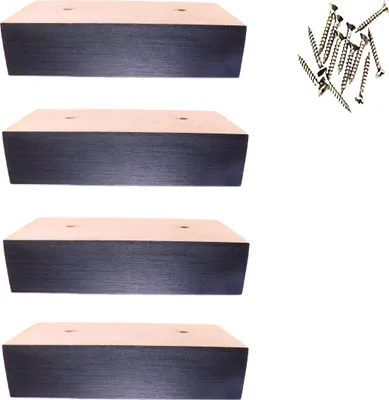 Four wooden furniture feet and a pile of screws on a white background.