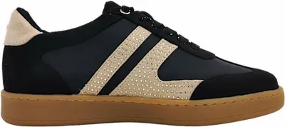 A side view of a black sneaker with beige accents and a brown sole.