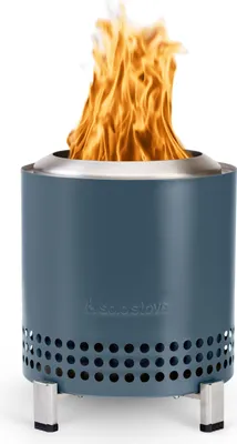 A blue Solo Stove fire pit with flames burning inside, set against a white background.