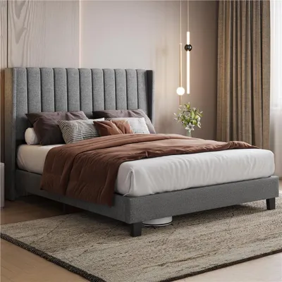 A bedroom scene with a bed and bedding.