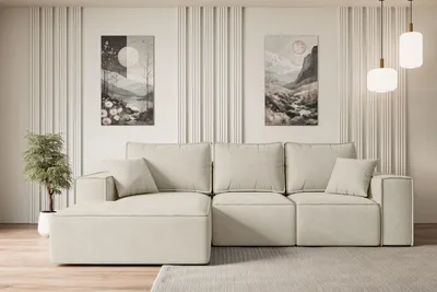 A modern living room setup featuring a sectional sofa, two pieces of abstract art, and pendant lighting.