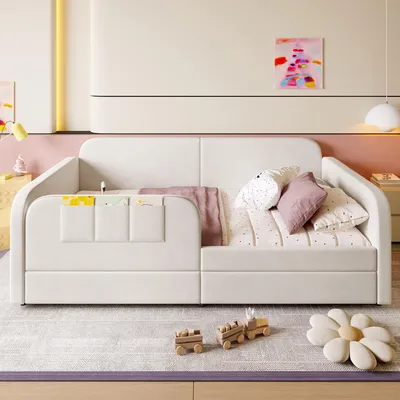 A child's bed with pillows and blankets in a brightly lit room.