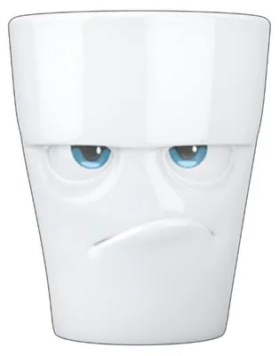 A white ceramic mug with a grumpy face design.