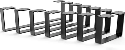 A set of black metal furniture legs arranged in a diagonal line against a white background.