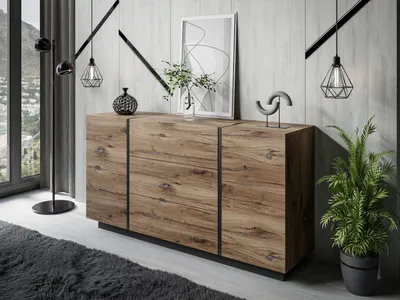 A modern living room with a wooden sideboard, a floor lamp, and decorative items.