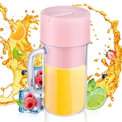 A pink and transparent portable blender filled with yellow juice, surrounded by splashes of juice and fruit slices.