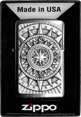 A Zippo lighter with a compass emblem is presented in its packaging.