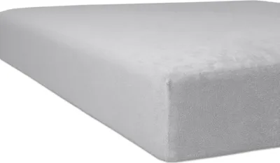 A close-up, angled view of a light gray fitted sheet or mattress cover.