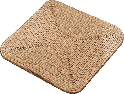 A square woven straw cushion on a white background.