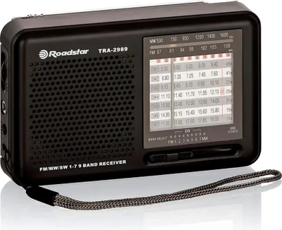 A black Roadstar TRA-2989 multiband radio is shown from a slightly elevated front-left angle against a light gray background.