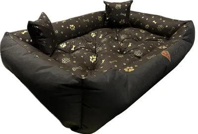 A dog bed with a paw print and bone pattern.