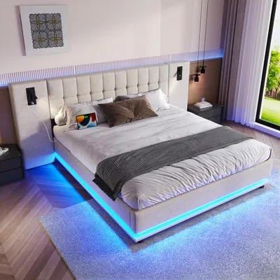 A modern bedroom with a large bed featuring LED lighting.