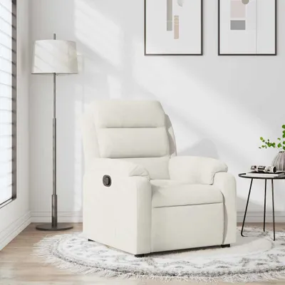 A cream-colored recliner chair is shown in a well-lit room with a floor lamp and artwork on the wall.