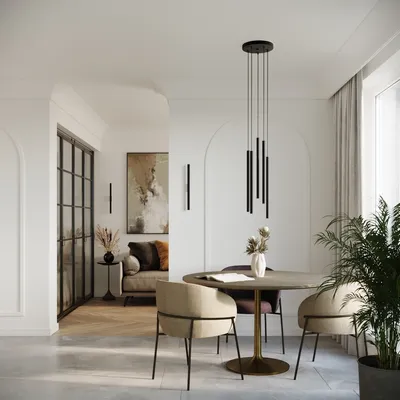 A modern dining area with a round table, chairs, and a pendant light fixture.