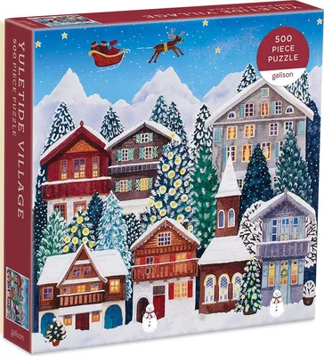 A puzzle box depicting a snowy village scene at Christmas time, with Santa and his reindeer flying in the sky.