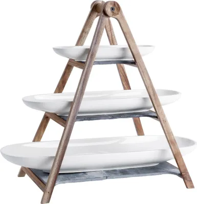 A three-tiered serving stand with white oval platters and a wooden frame.