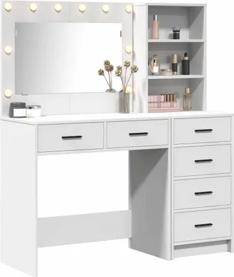A white vanity table with a mirror and shelves, displaying various cosmetic items and decorative elements.