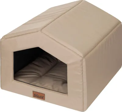 A beige dog house with a brown cushion inside, shown from a slightly elevated side angle.