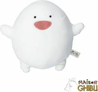 A white plush toy with a pink mouth and black eyes, standing on a white background. A small tag is attached to its side, and a Ghibli logo is visible in the bottom right corner.