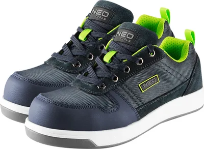 A pair of dark blue and gray work shoes with neon green accents, shown from a diagonal angle on a white background.