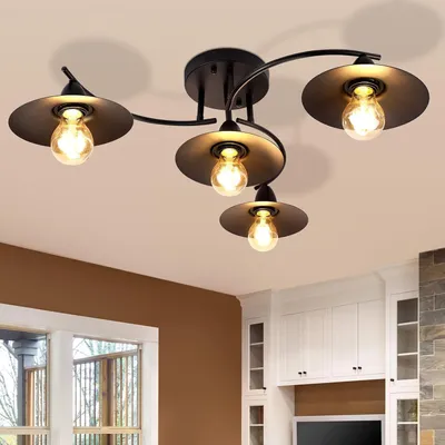 A black ceiling light fixture with four bulbs is shown against a white ceiling.