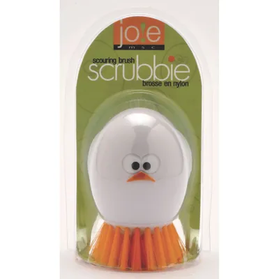 A product shot of a scouring brush shaped like a chick, packaged in clear plastic.