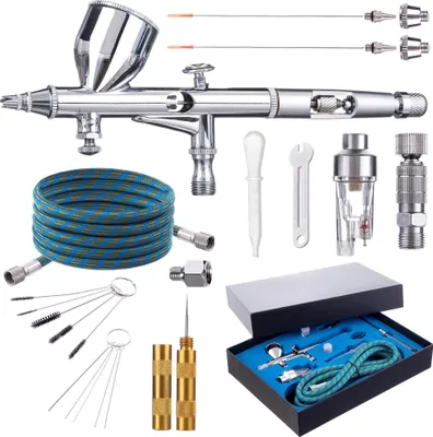 A collection of airbrushing tools and accessories laid out on a white background.