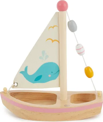 A wooden toy sailboat with a whale design on the sail, set against a white background.